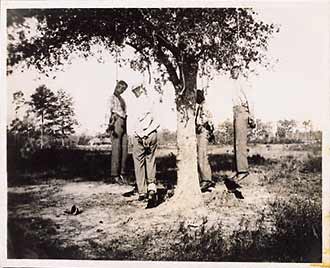 The lynching of four unidentified African Americans. Circa 1900, location unknown.