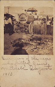 A lynch mob and the smoldering remains of an Henry Gentry an African American. 1910, Belton, Texas. Gelatin silver print.