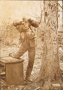 The lynching of Lee Hall, his body hung from a tree, bullet hole in head, ears cut off, discarded cookstove and trash.