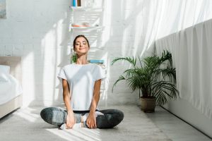 happy girl with closed eyes practicing yoga 