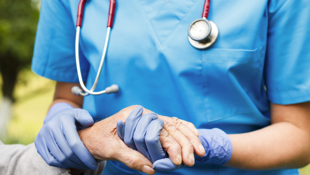 medical worker holding a patient's hand