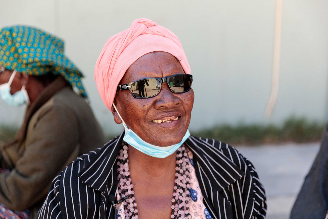 Smiling woman with dark sunglasses
