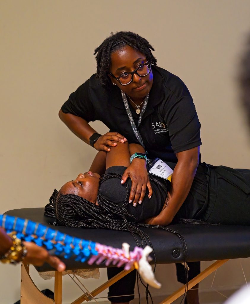 Student from the Urban Youth Academy receives chiropractic instruction.