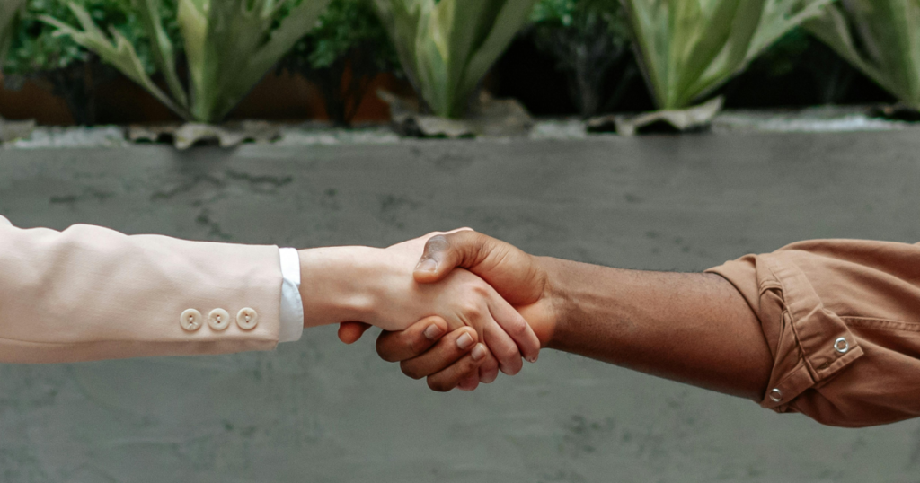 two people shaking hands
