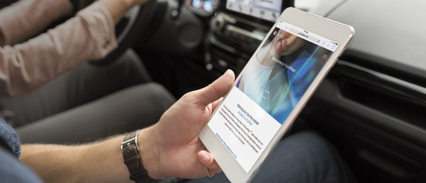 person using Ford's FordPass app on a tablet