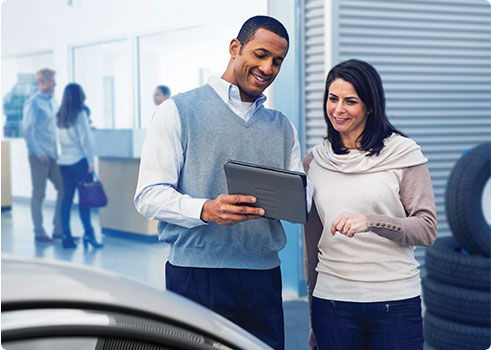 man showing lady a tablet