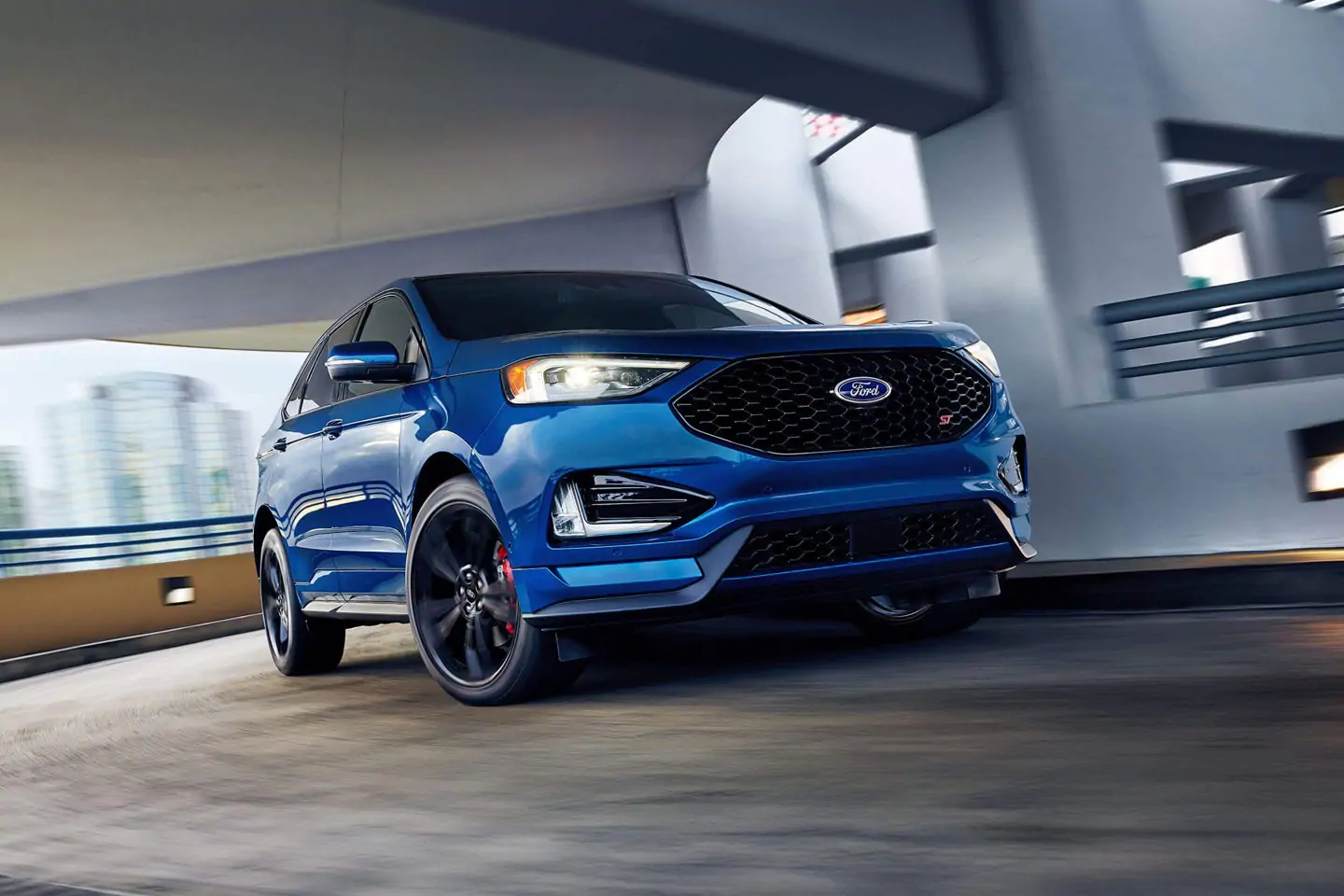 blue 2019 ford edge st driving in parking garage