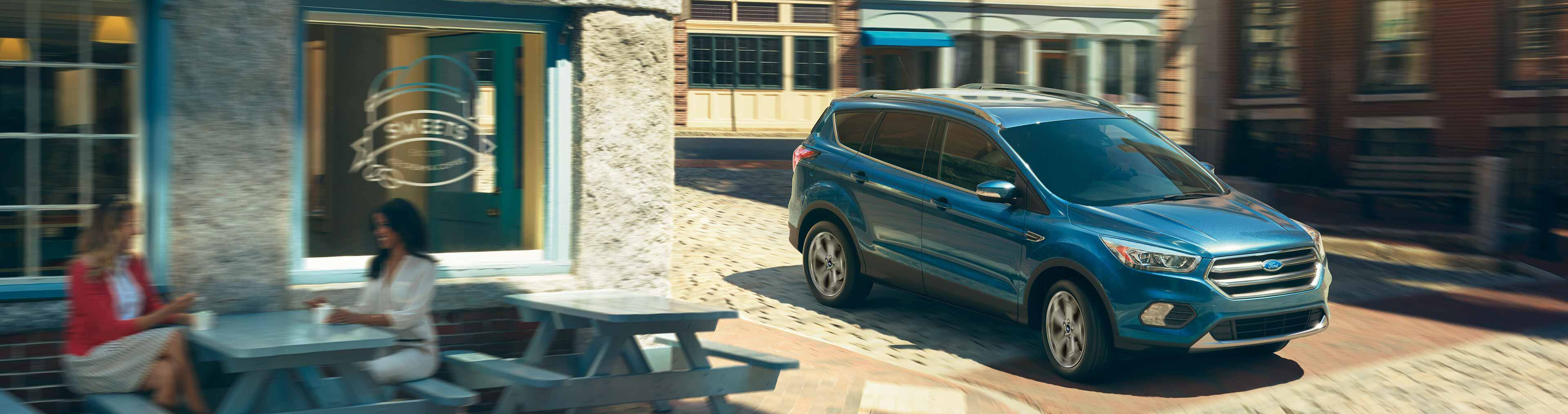 blue 2019 ford escape driving past an ice cream shop