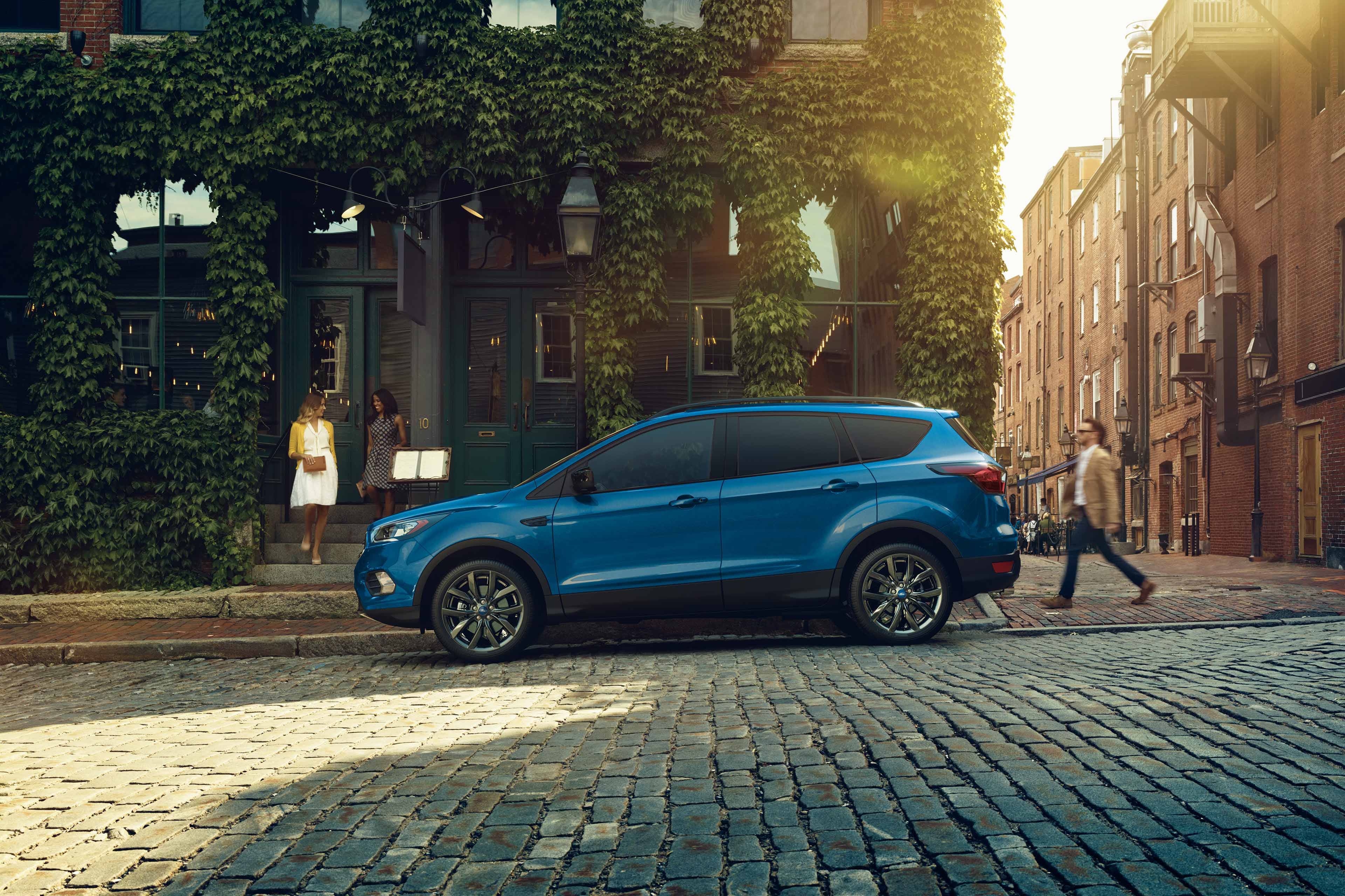 blue 2019 ford escape parked on a stone street