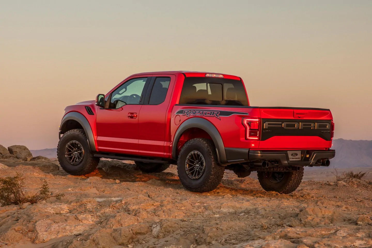 red 2019 ford f-150 raptor parked on a mountain top