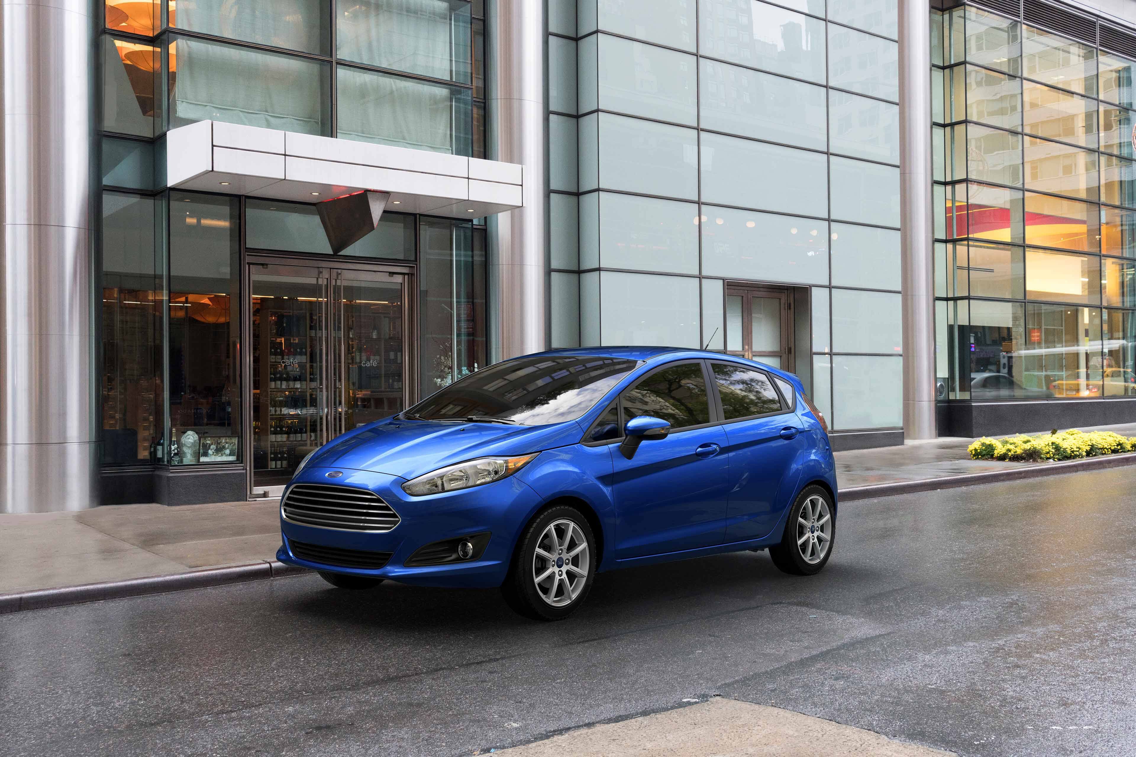 blue 2019 ford fiesta parked in the city