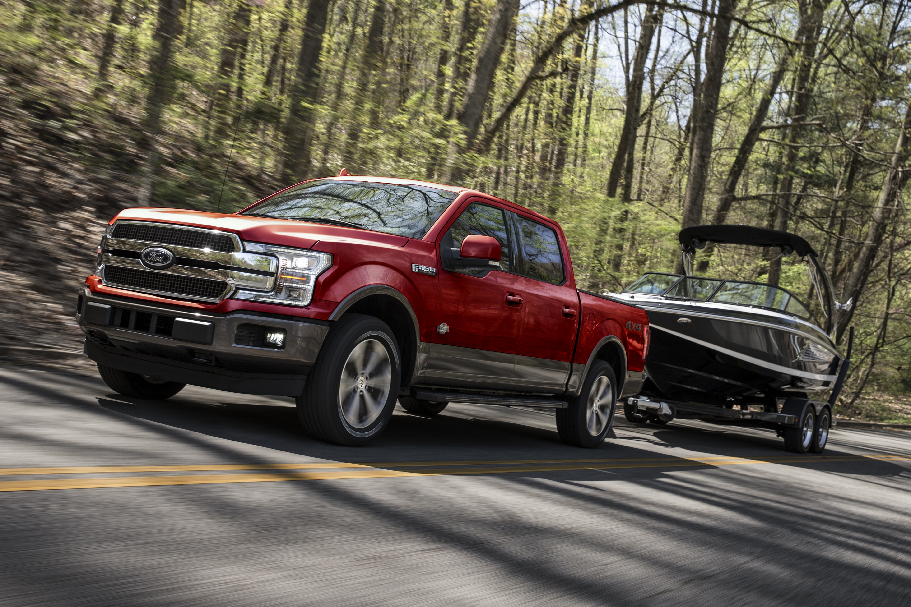 red 2020 ford f-150 driving through the woods