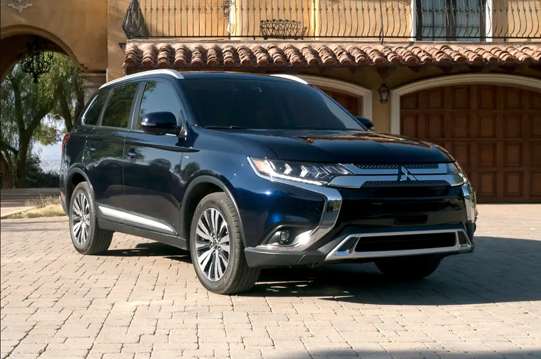 blue 2019 mitsubishi outlander parked in front of a building
