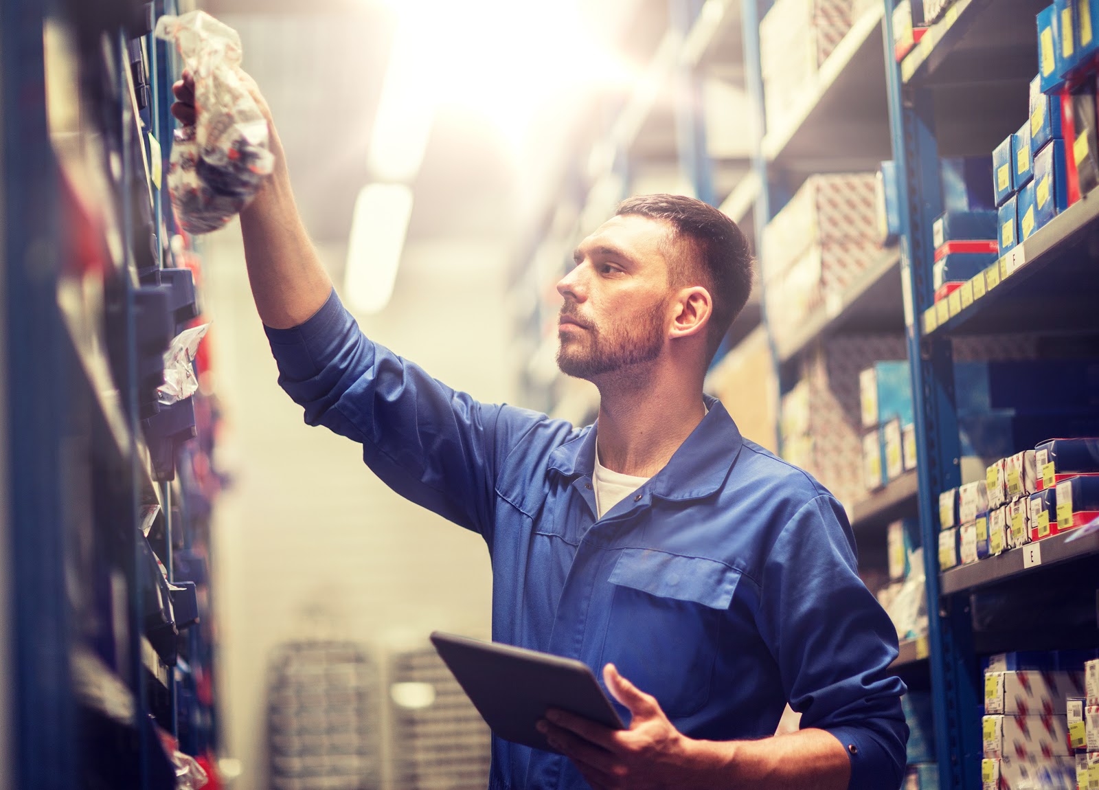 Mechanic looking through inventory of parts