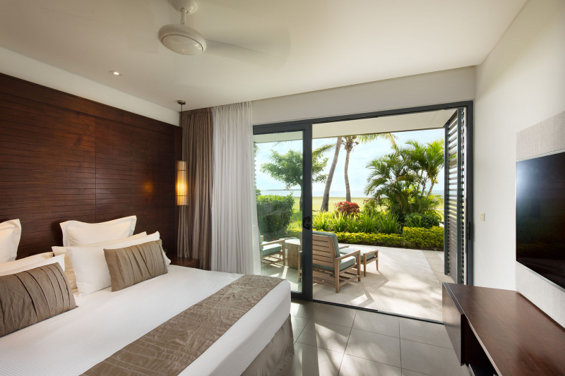Bedroom with king bed and step-free patio with ocean views.