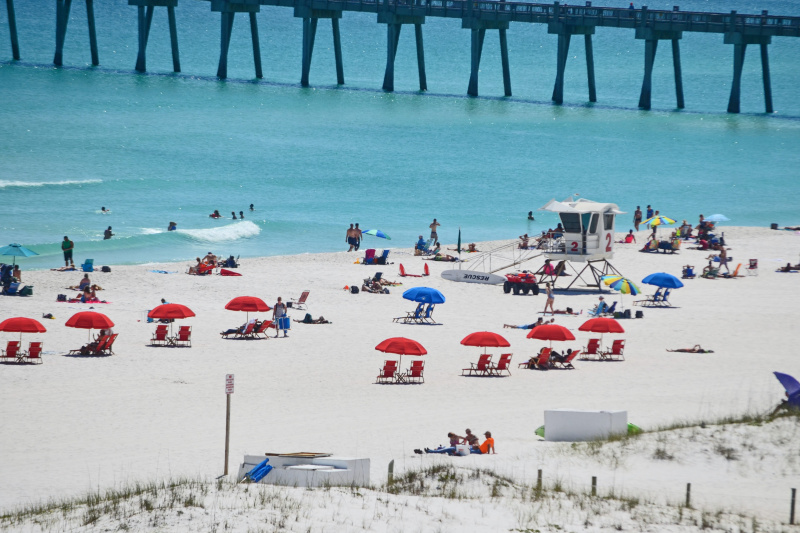 Parasols and beach chairs on the white sand