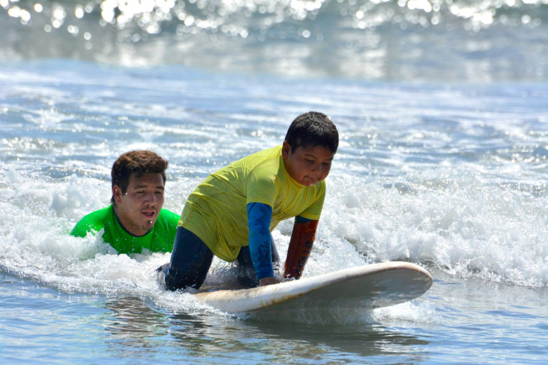 A boy enjoying surf lessons