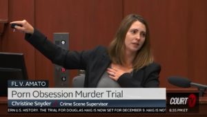 A witness motions with her arms