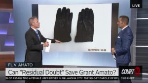 Vinnie Politan and another man show gloves in a monitor