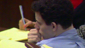 Erik Menendez listens to Lyle Menendez testify