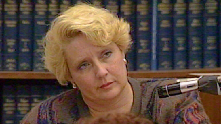 Betty Broderick sits with her head tilted