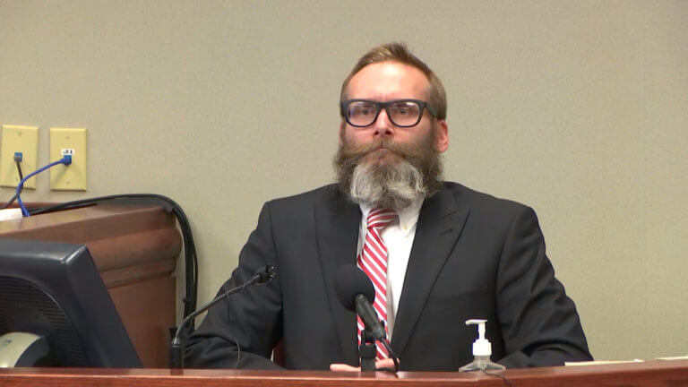 man with beard testifies in court