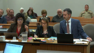 attorneys sit at table in court