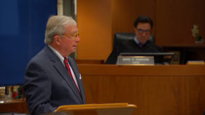 A man in a suit speaks in court