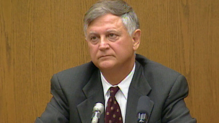 A man in a suit testifies in court