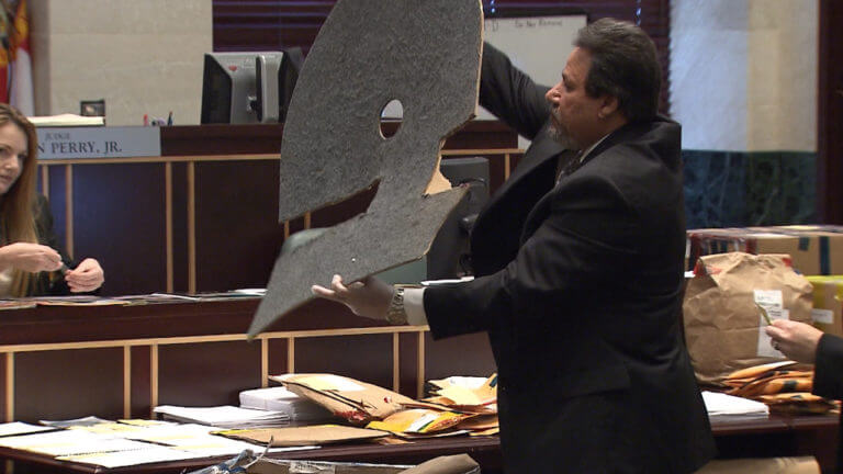 An attorney holds up evidence for the jury