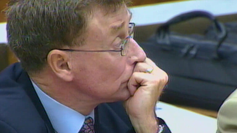 Michael Peterson holds his hand to his face