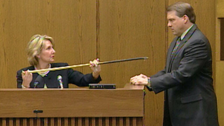 A woman shows evidence to the jury