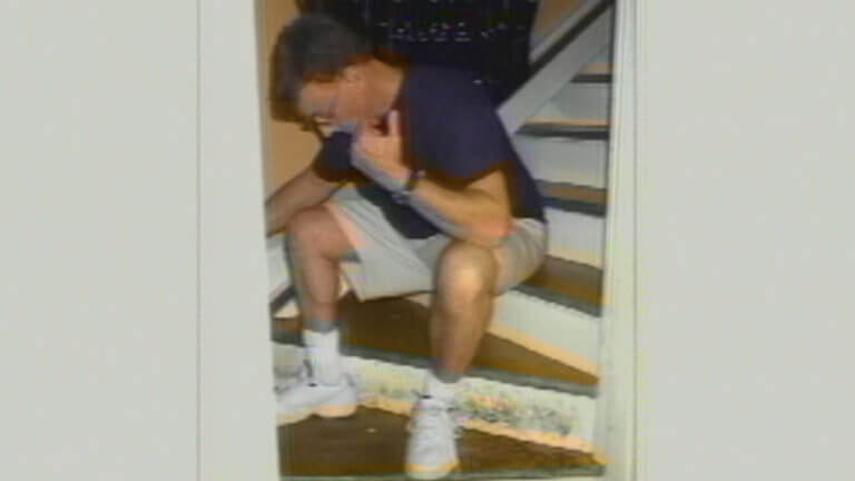 a photograph shows a man sitting on the stairs