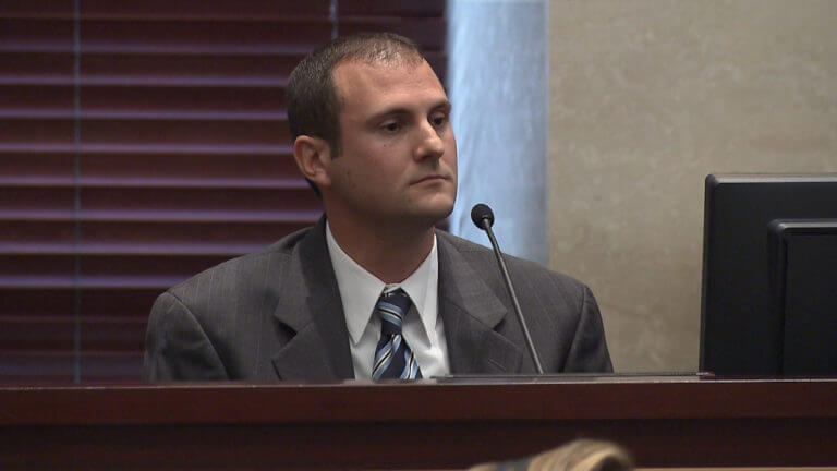 A man testifies into a microphone in court