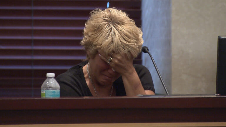 Cindy Anthony cries into her hand while testifying