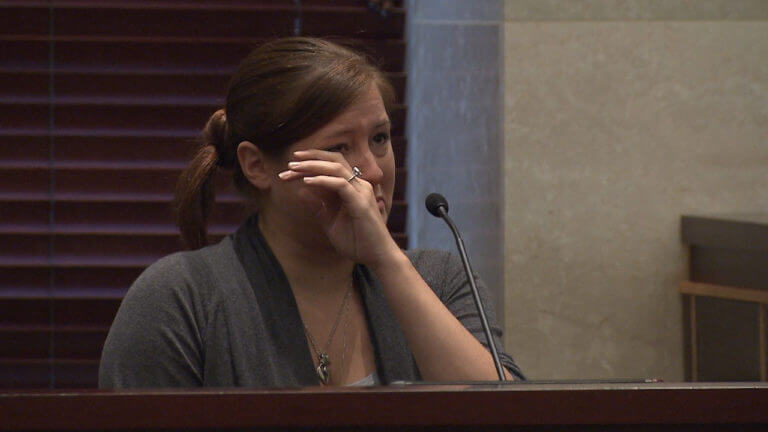 A woman is tearful while testifying in court