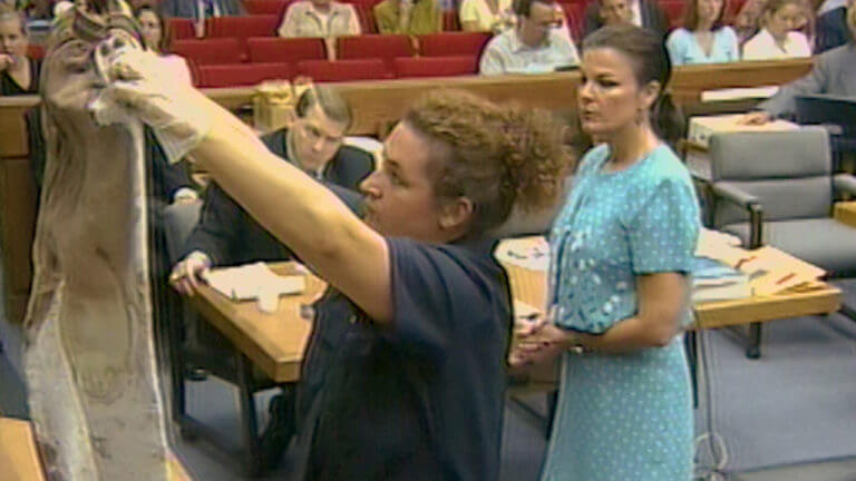 A woman holds up evidence in court