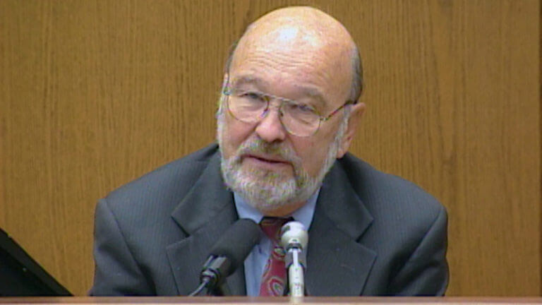 A man in a suit testifies in court