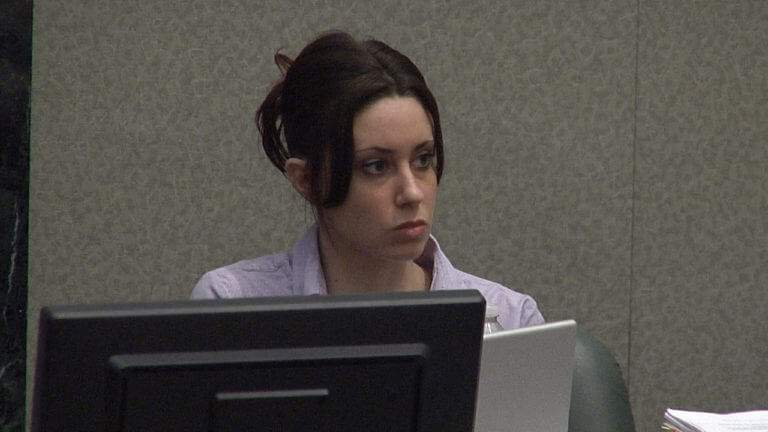 Casey Anthony sits behind computer screens