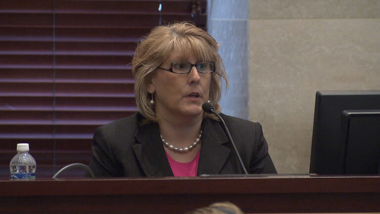 A woman testifies in court.