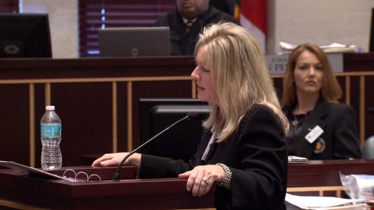 A woman addresses the jury