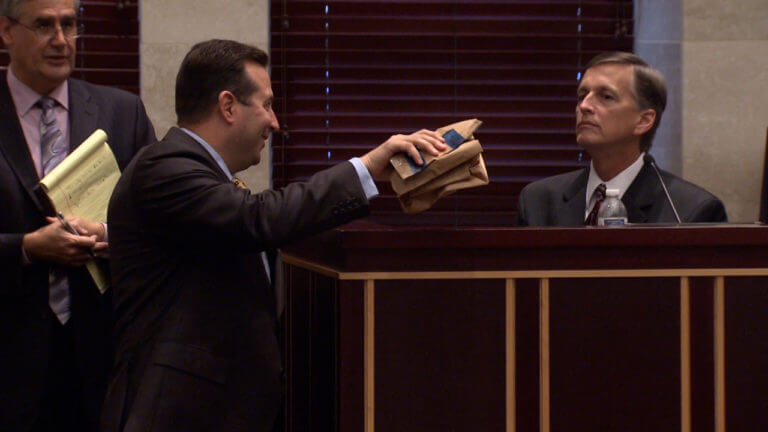 Jose Baez shows a piece of evidence to the jury