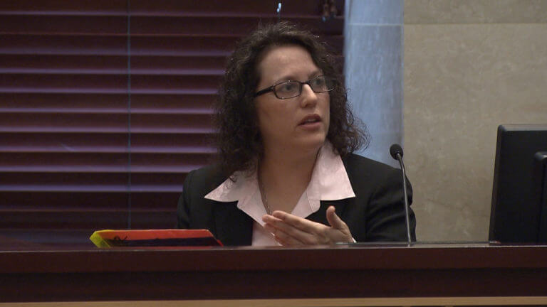 A woman testifies in court.