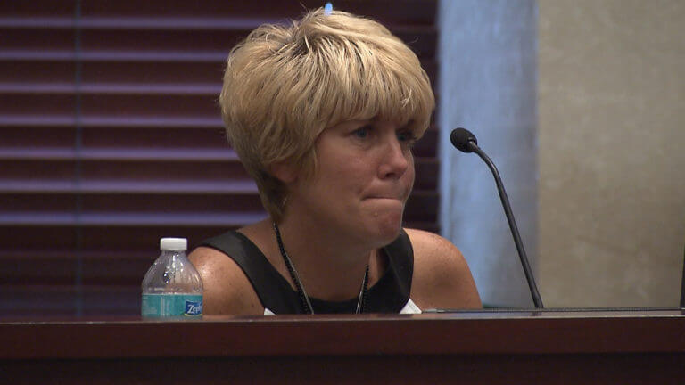 Cindy Anthony pulls in her lips as she sits on the witness stand.