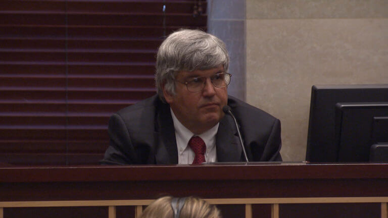 A man testifies in court.