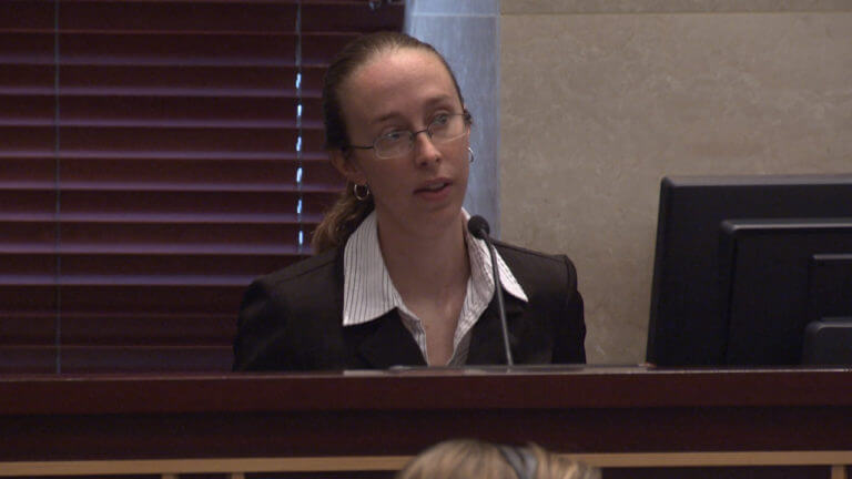 A woman testifies in court.