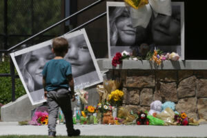 A boy checks out a memorial for Tylee Ryan, 17, and Joshua 