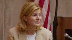 A woman testifies in court.