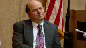 A man in a suit testifies in court