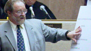 A man points to a poster in court